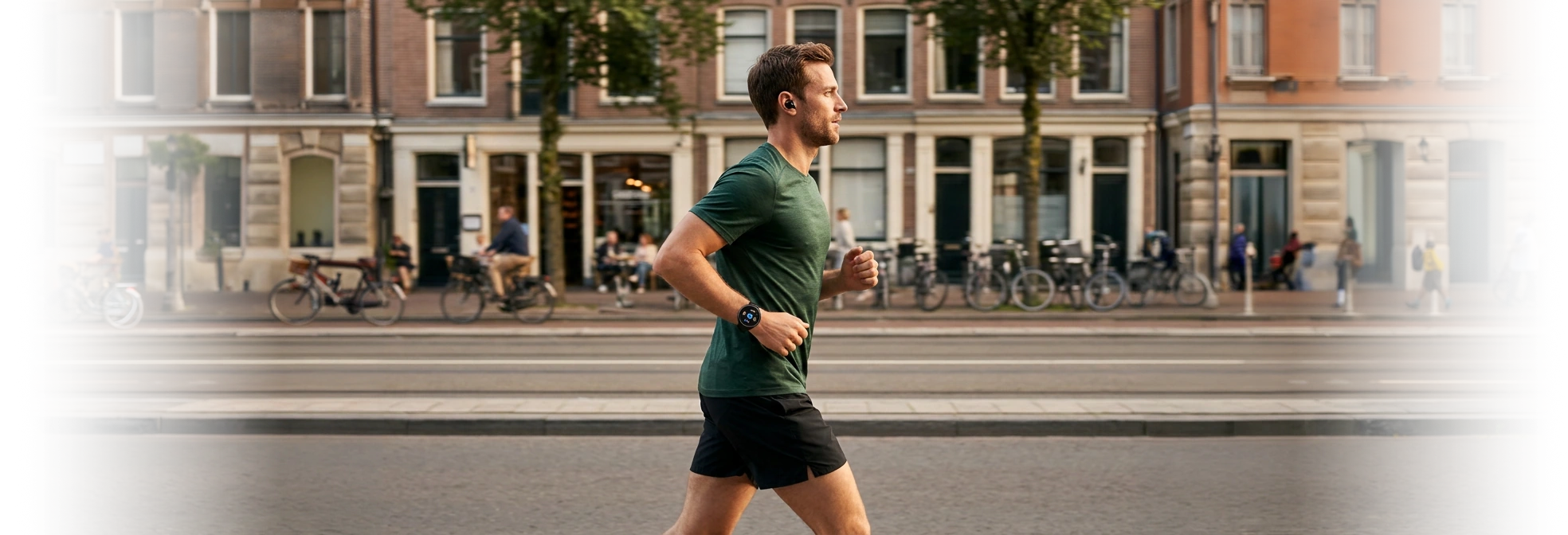 A runner listening to audio with earbuds and a smartwatch on a city street